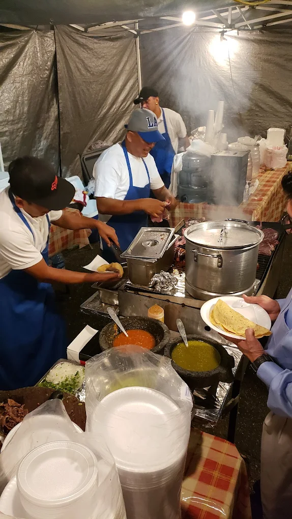 La Humadera cooks at work behind the grill